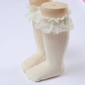Macro detail view of girls' white Lolita mesh socks featuring elegant ruffled lace trim