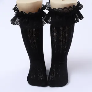 Detailed view of girls black lace ruffled mesh socks with elegant openwork pattern
