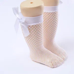 White fishnet mesh socks for girls featuring a delicate white satin ribbon bow detail