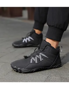 Detailed view of black minimalist barefoot winter boots with a warm plush lining.