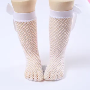 Detailed view of white fishnet socks for girls featuring elegant satin bows.