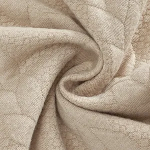Vista macro detallada de la textura del tejido jacquard beige para sudadera de invierno