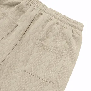 Primer plano del tejido jacquard beige con patrón de hojas para chándal de hombre