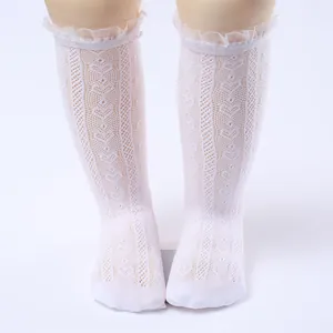Exquisite detail view of white lace ruffled mesh knee-high socks for baby girls