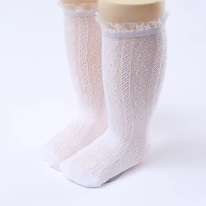 Close-up of white Lolita style girls' lace ruffle fishnet knee high socks