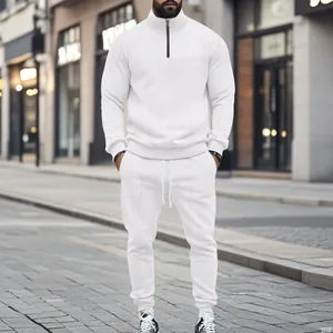 Detailed close-up of white men's textured tracksuit featuring a half-zip stand collar design