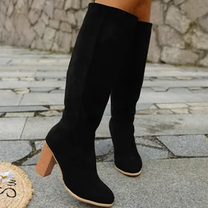 Elegant black suede knee-high boots with chunky wooden-style high heels for women.