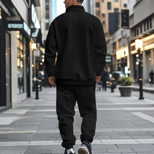 Detailed back view of men's black jacquard sports set in an urban street scene
