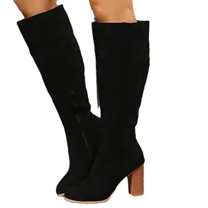 Elegant black suede knee-high boots featuring a stylish chunky wood-grain high heel