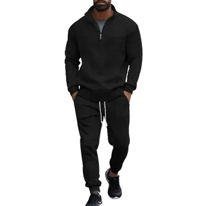 Detailed view of men's black textured tracksuit set with half-zip pullover and pants