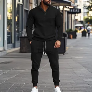 Stylish urban men's black jacquard sportswear set featuring quarter-zip pullover and joggers