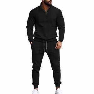 Full-body view of men's black jacquard tracksuit set with quarter-zip pullover and joggers