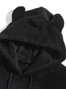 Close-up macro detail of soft plush coral fleece hood featuring cute bear ears design