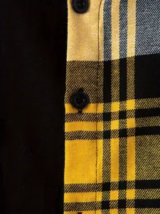 Detailed macro shot of yellow and black plaid fabric and buttons of a men's shirt