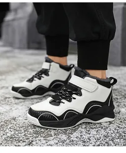 Close-up view of boys black and white fleece-lined winter sports basketball shoes for kids