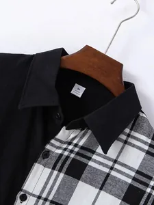 Detail of black and white plaid patchwork shirt collar with material tag.