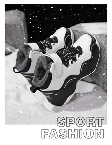 Detailed view of boys' fur-lined high-top winter sports shoes in a snowy setting.