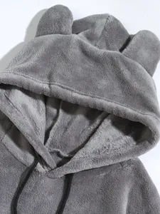 Close-up of grey coral fleece hoodie with plush bear ears and soft fabric texture