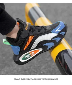 Détail des baskets d'hiver pour garçons, doublées de peluche, en noir, bleu et orange.