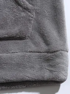 Macro view of grey coral fleece fabric showing soft texture of men's hoodie