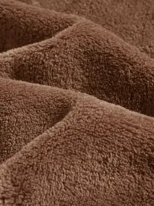 Detailed macro shot of premium soft brown coral fleece fabric texture for men's hoodie