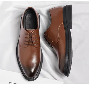 Detailed close-up of brown pointed-toe men's business dress shoes with gradient finish.