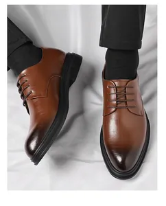 Close-up of men's brown gradient pointed toe leather dress shoes with lace-up detail