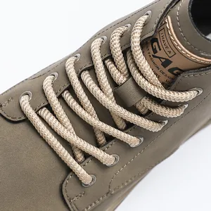 Close-up detail of sturdy braided laces on retro men's high-top outdoor work boots
