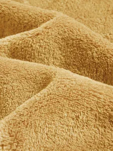 Close-up detail of soft yellow coral fleece fabric for men's winter hoodie jacket