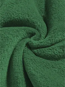 Makroaufnahme der weichen Textur des dunkelgrünen Korallenvlies-Stoffes im Detail