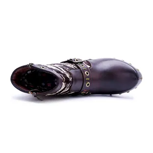 Top view of handmade distressed leather ankle boots with patchwork animal fur trim.