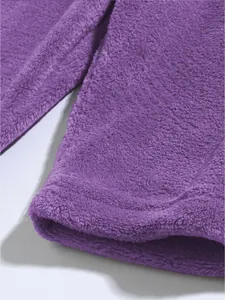 Detail of soft purple coral fleece fabric and double-stitched hem of casual shorts.