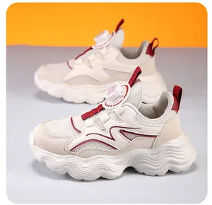 Dettaglio laterale di scarpe da ginnastica in mesh per bambini con accenti rossi e fibbia
