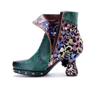 Detailed side view of boho leather ankle boots featuring floral patchwork and metal studs
