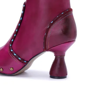 Close-up of handmade magenta leather ankle boot heel with artistic contrast stitching