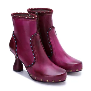 Detailed view of handmade burnished magenta leather ankle boots with side zipper.