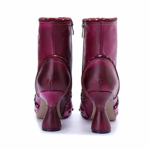 Back view of handmade burgundy leather ankle boots with colorful stitching and flared heels.