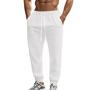 Detailed macro view of white knitted men's sweatpants with textured cable jacquard pattern