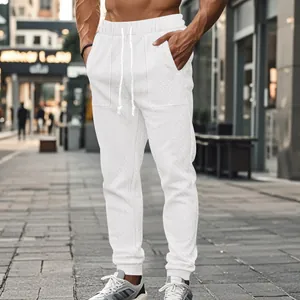 Detailed close-up view of men's white cable-knit casual joggers with adjustable drawstring waist