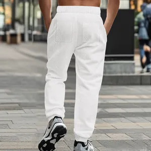 Detailed back view of men's white knitted joggers with textured cable pattern