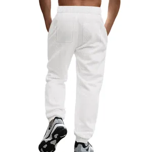 Back view of men's white knit jacquard joggers with breathable texture and elastic cuffs