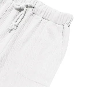Detail view of men's white knit casual pants showing drawstring and fabric texture