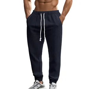 Detailed view of men's dark navy knit textured joggers with white drawstring waist