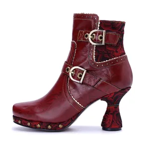 Detailed side view of handmade red leather ankle boots featuring elegant rose floral patterns