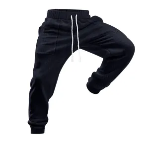 Detailed macro view of men's dark knitted joggers featuring textured pattern and white drawstring