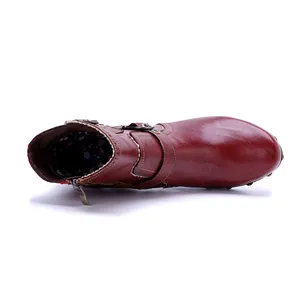 Top view of handmade burgundy leather boots with floral lining and side zipper detail.