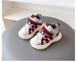 Detailed view of children's fleece-lined winter sneakers with cute cartoon eye accents.