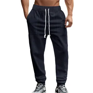 Detailed view of dark navy cable knit men's joggers with white drawstring waist