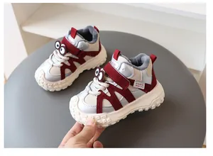 Close-up of cute cartoon eyes and thick fleece lining on children's winter sports sneakers