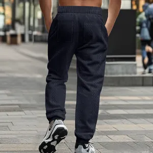 Back view of men's navy knit joggers showing textured jacquard pattern and rear pockets